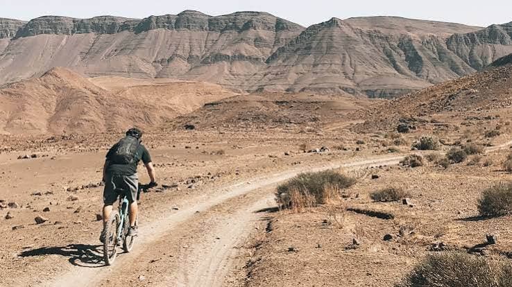 Mountain biker riding an unpaved track in southern Morocco