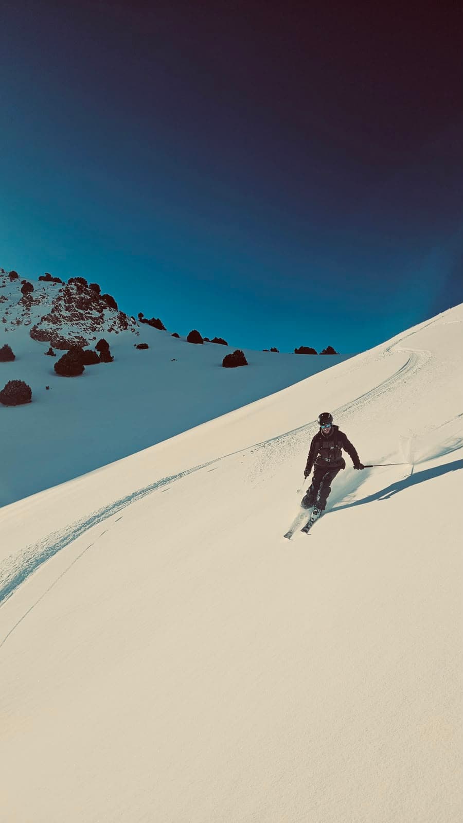 Skier descending a snow-covered slope in the Moroccan Atlas