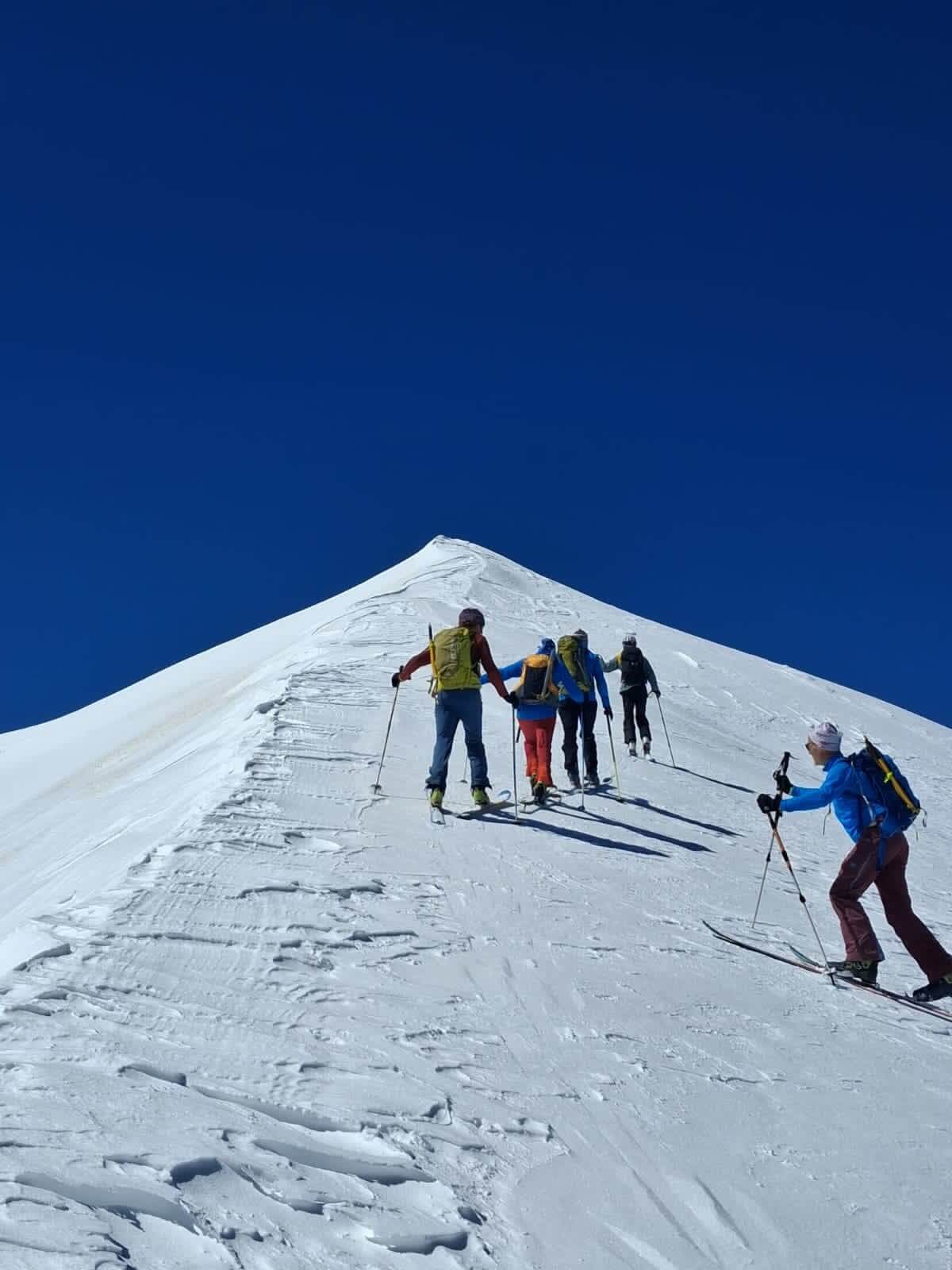 Skiers on a summit in the Moroccan High Atlas